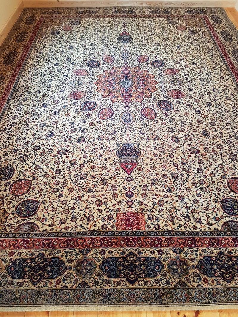 Image shows a large intricately patterned rug.